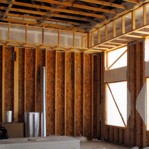 Installing Recycled Blue Jean Denim Insulation In Wall Frame Stock